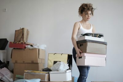 Photo of a Woman Moving Boxes