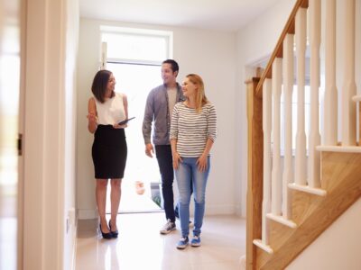 Experienced Denver real estate advisor showing a modern home to first-time buyers