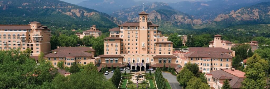 The Broadmoor buildings sit in front of small hills.