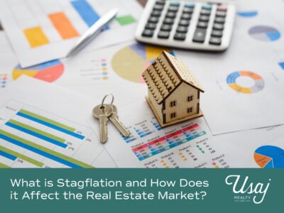 A photo of market documents with a calculator, toy house, and key ring sits above white text on a teal background that reads, "What is Stagflation and How Does it Affect the Real Estate Market?" next to a white Usaj Realty logo.