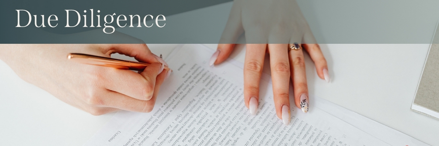 White text over a gradient reads, "Due Diligence" in front of a photo of a person signing a contract.