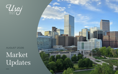 A white Usaj Realty CO logo sits in the upper left-hand corner. Below, white text on a dark gray background reads," August 2026 Market Updates" for the Denver metro area. To the right, a photo of downtown Denver, CO.