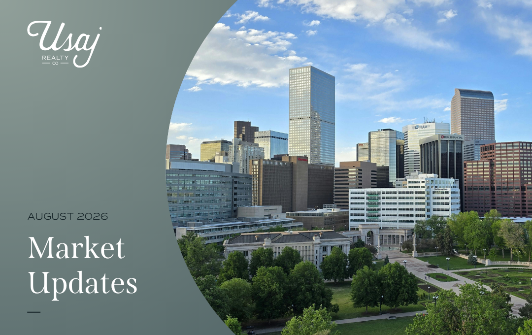 A white Usaj Realty CO logo sits in the upper left-hand corner. Below, white text on a dark gray background reads," August 2026 Market Updates" for the Denver metro area. To the right, a photo of downtown Denver, CO.